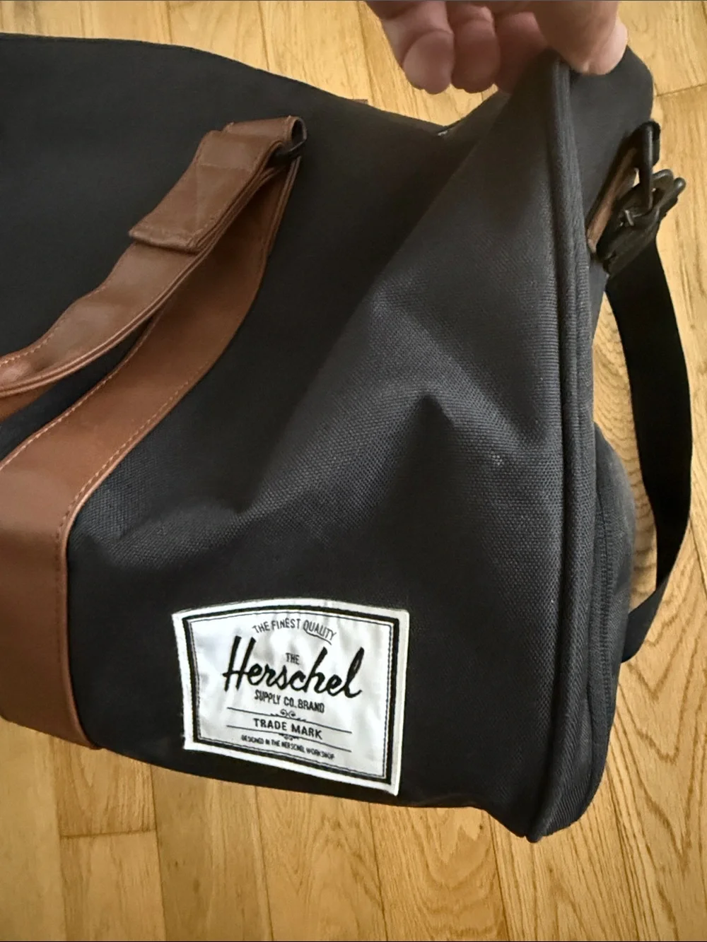 Herschel Supply Company Black Duffel with Brown Straps and White Piping. 43L.